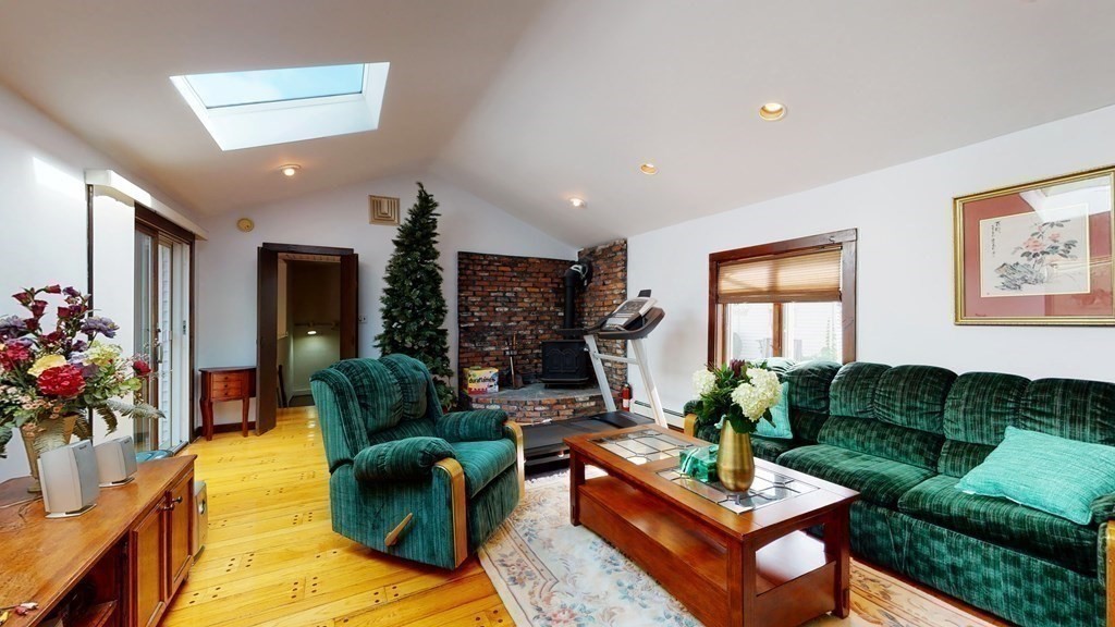 107 Truman Road Newton, MA 02459 - Photo 8 of 22 a living room with furniture fireplace and a large window
