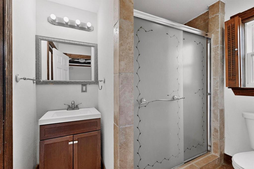 401 East Miller Road Garland, TX 75041 - Photo 8 of 18 a bathroom with a shower sink and toilet