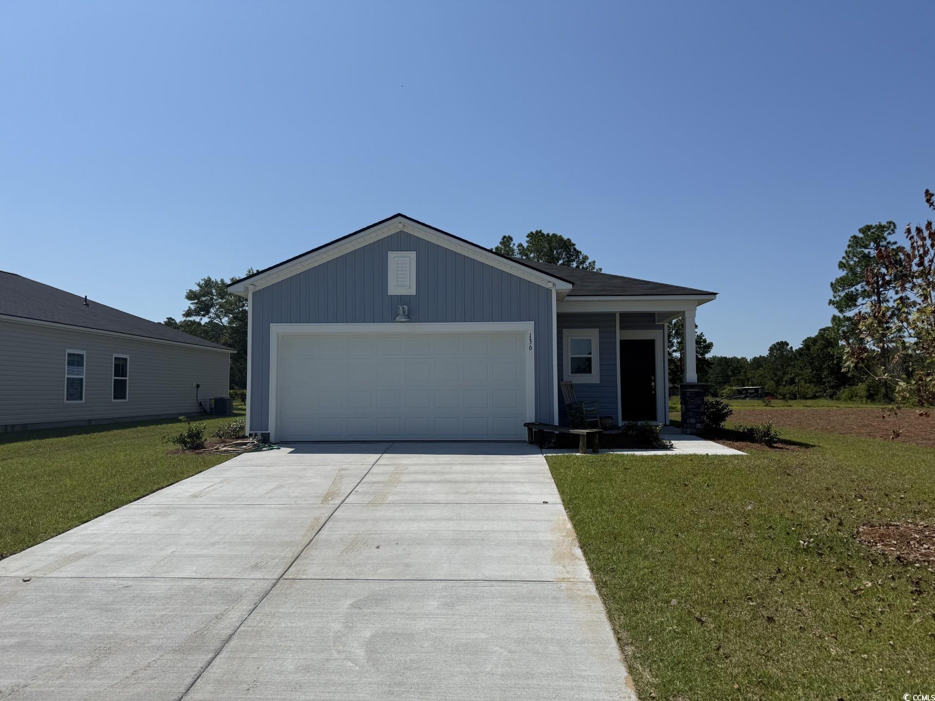 View of front facade featuring concrete driveway,