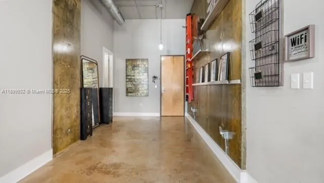 a view of hallway with a large window and stainless steel appliances