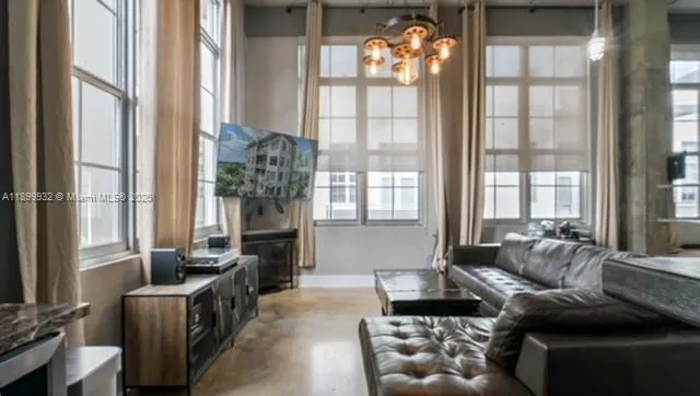 a view of a hallway with workspace and a refrigerator