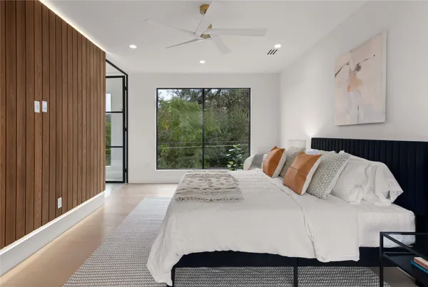 a bedroom with a large bed and a window