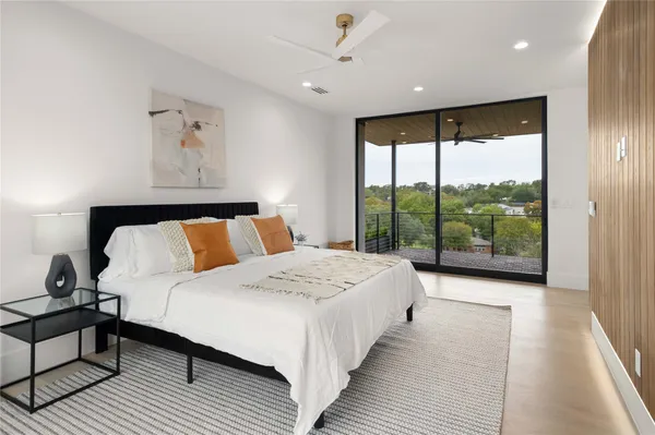 a bed room with a bed and a large window