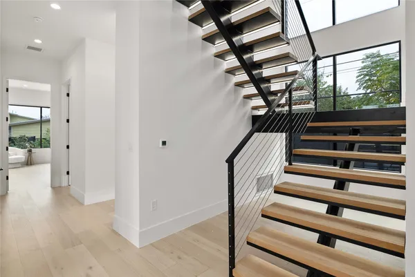 a view of entryway and hall with wooden floor