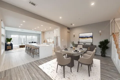 a dining room with furniture and wooden floor