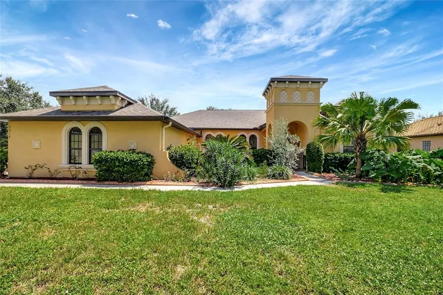 a front view of a house with a garden and yard