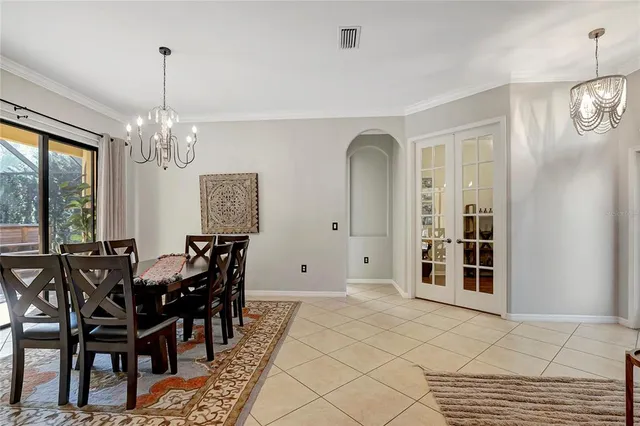a view of a dining room with furniture and chandelier