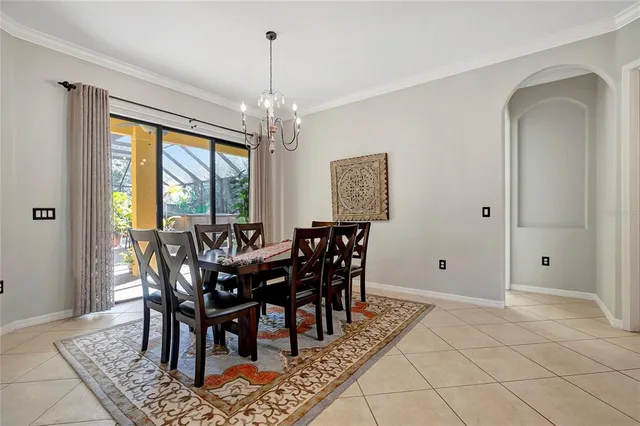 a view of a dining room with furniture and a chandelier