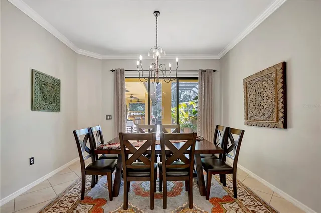 a view of a dining room with furniture a chandelier and wooden floor