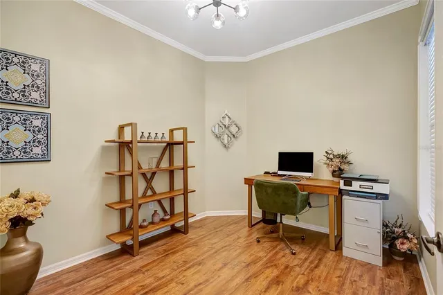 a bedroom with a bed chandelier and a window