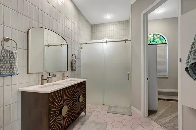 a kitchen with stainless steel appliances granite countertop a sink refrigerator and cabinets