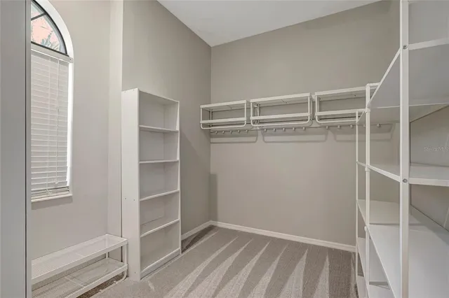 a kitchen with stainless steel appliances granite countertop a sink refrigerator and cabinets