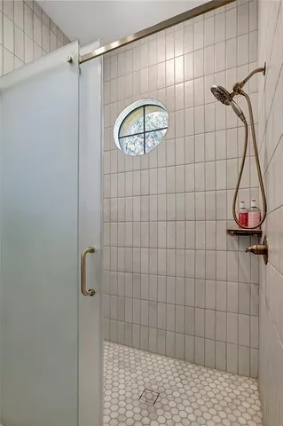 a living room with furniture kitchen view and a chandelier