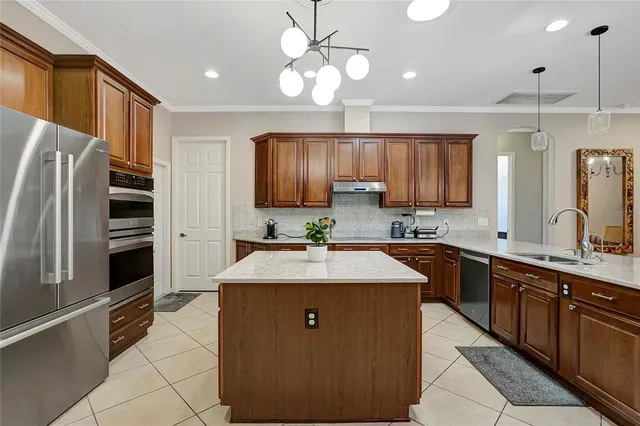 a kitchen with a sink stove and microwave