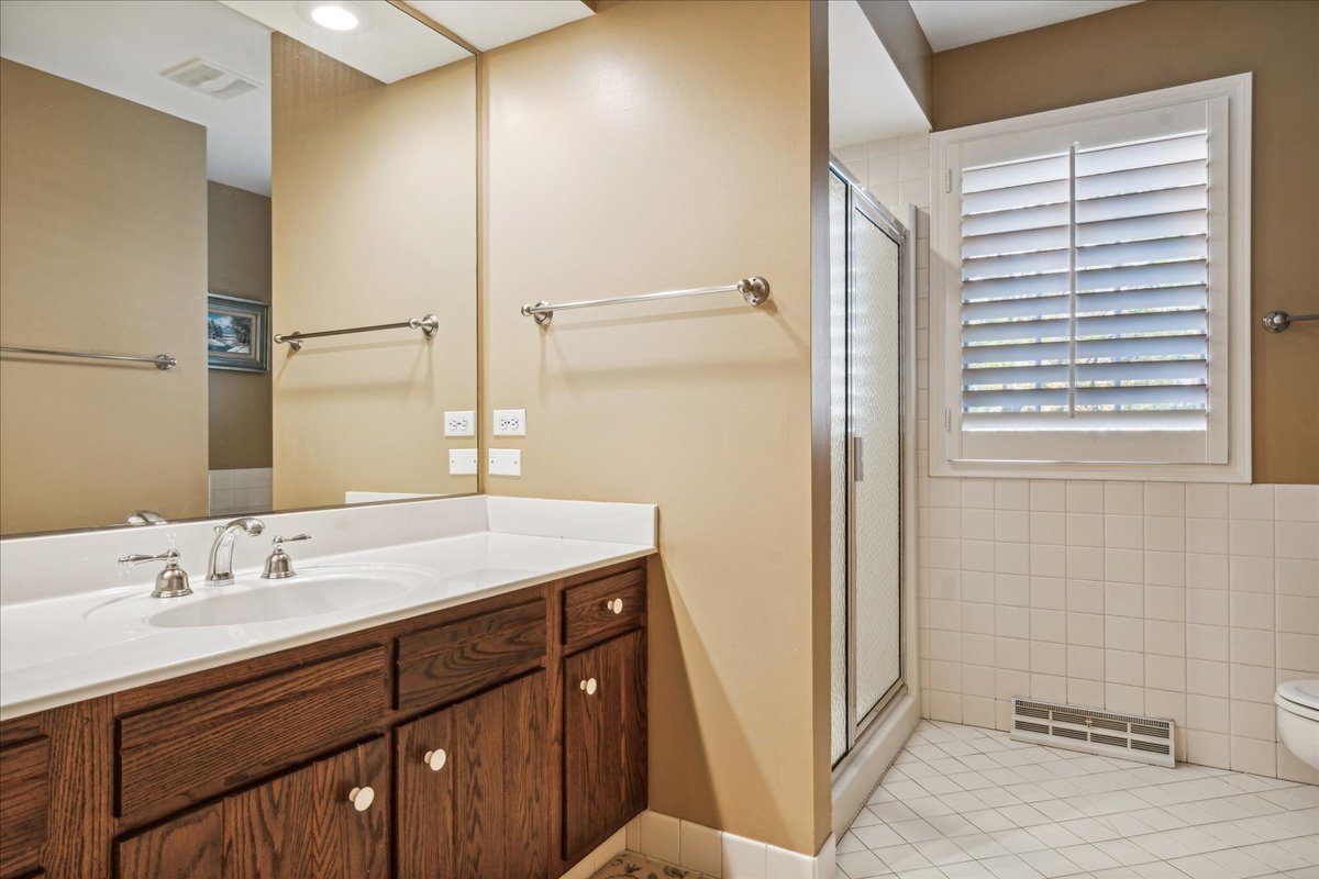 555 Douglas Drive Lake Forest, IL 60045 - Photo 23 of 32 a bathroom with a sink and a mirror