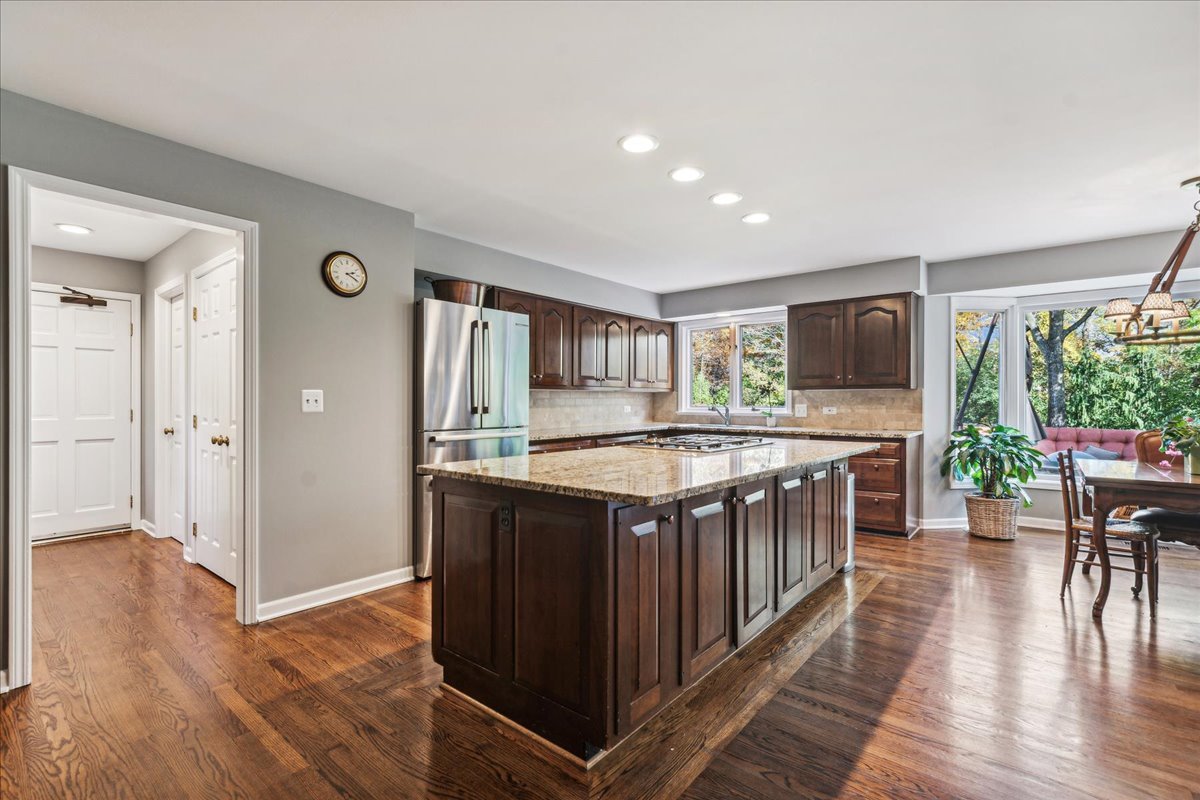 555 Douglas Drive Lake Forest, IL 60045 - Photo 7 of 32 a kitchen with stainless steel appliances granite countertop a stove and a wooden floors