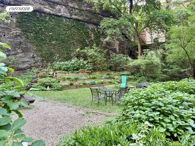 a view of a chair and table on the garden