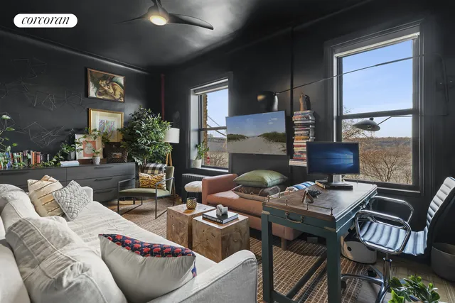 a living room with furniture and a potted plant