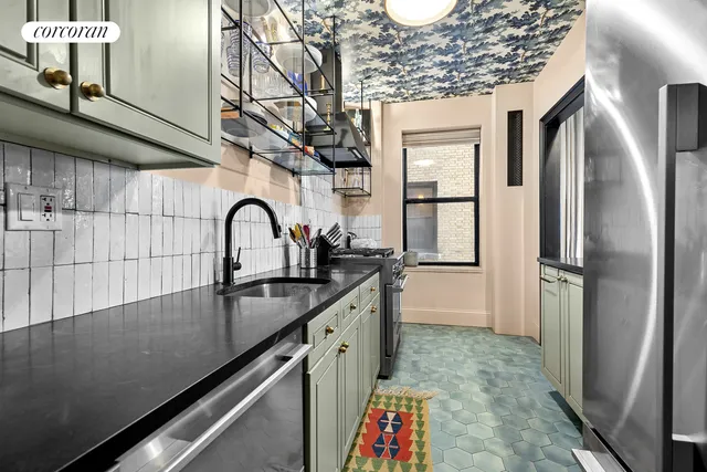a kitchen with stainless steel appliances granite countertop a sink a stove and a refrigerator