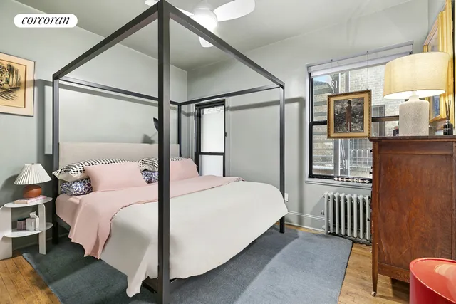 a bedroom with a bed table and window