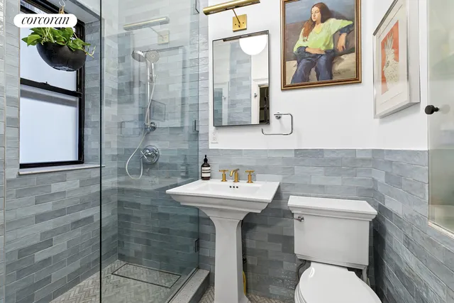a bathroom with a sink mirror and toilet