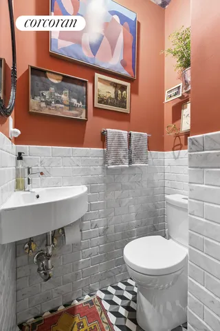 a bathroom with a toilet a sink and mirror