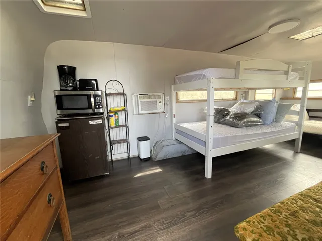 a bedroom with furniture and wooden floor
