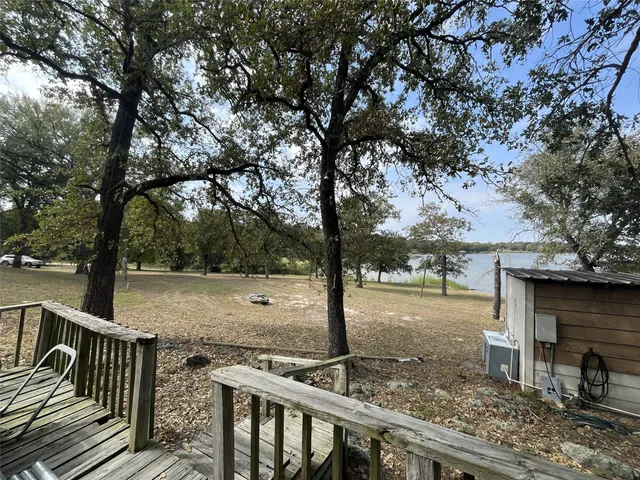 a view of a yard with wooden fence