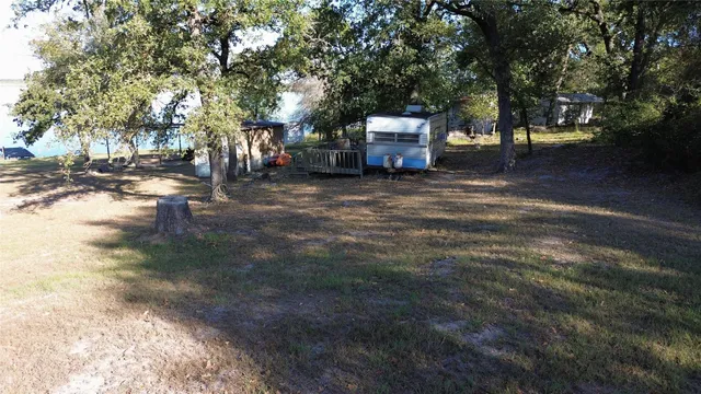 a backyard of a house with a yard and outdoor seating
