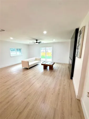 a view of an empty room and wooden floor