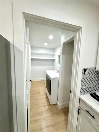 a view of a kitchen from the hallway