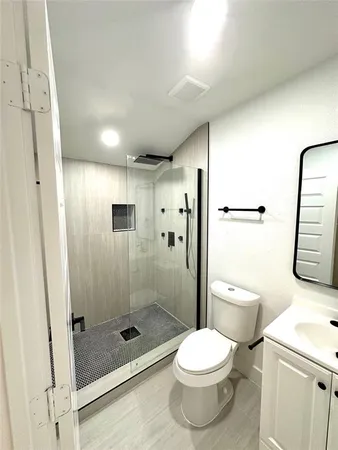 a bathroom with a shower and a toilet