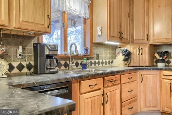 a kitchen with stainless steel appliances granite countertop a stove and a microwave