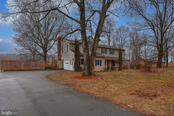 a tall house with trees in front of it