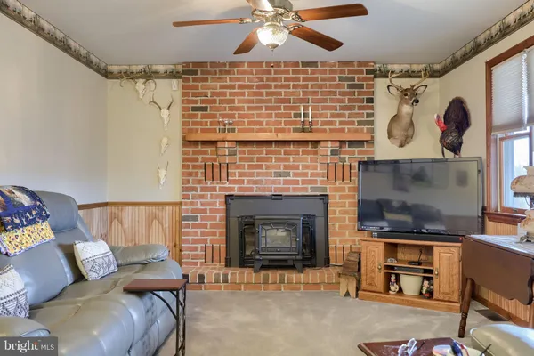a living room with furniture a fireplace and a large window