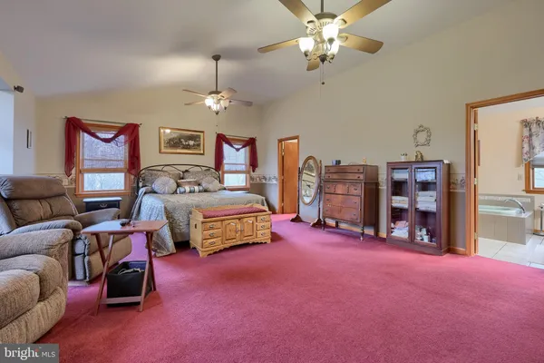 a bed room with furniture and a flat screen tv
