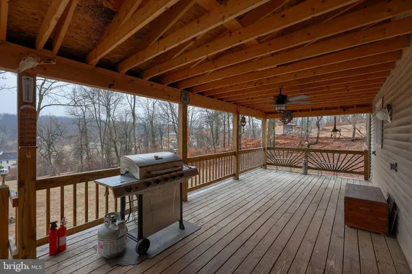 a view of a porch with wooden fence and floor