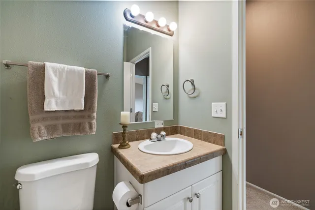 a bathroom with a sink toilet and mirror