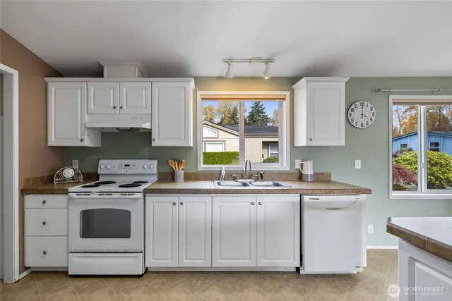 a kitchen with a stove sink and cabinets
