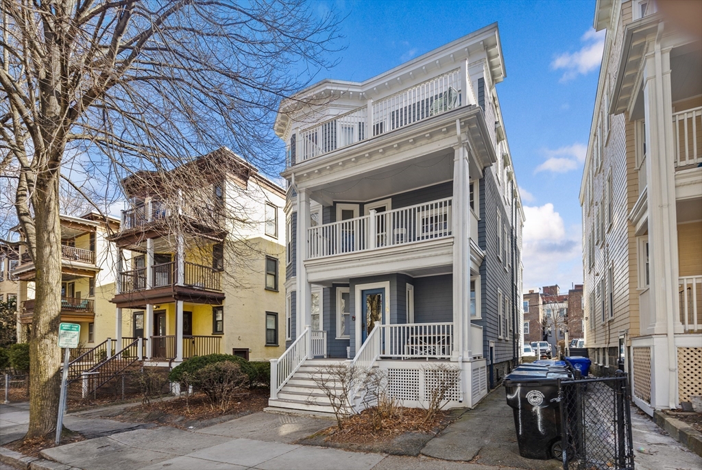 119 Browne Street, Unit 1 Brookline, MA 02446 - Photo 1 of 15 a front view of a building with many windows