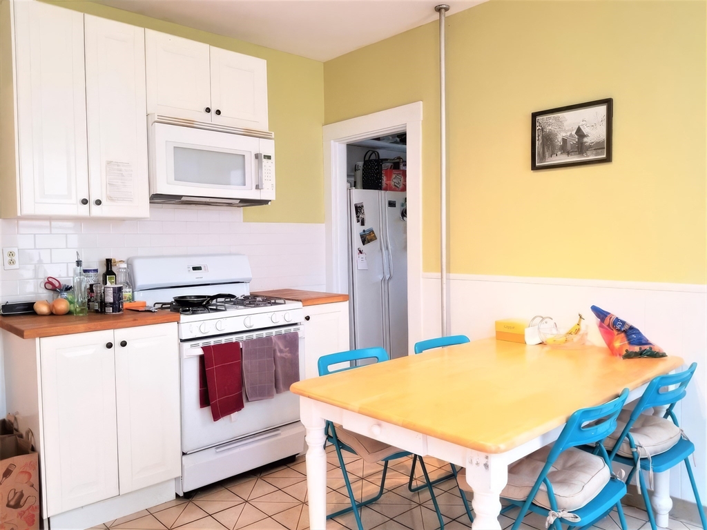 119 Browne Street, Unit 1 Brookline, MA 02446 - Photo 11 of 15 a kitchen with stainless steel appliances a stove a sink and a refrigerator