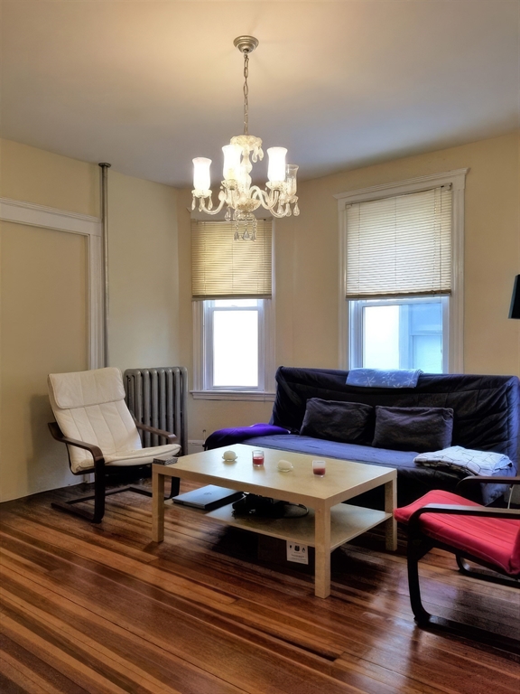 119 Browne Street, Unit 1 Brookline, MA 02446 - Photo 14 of 15 a living room with a table chairs and a window