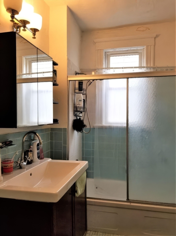 119 Browne Street, Unit 1 Brookline, MA 02446 - Photo 2 of 15 a bathroom with a sink a toilet and shower