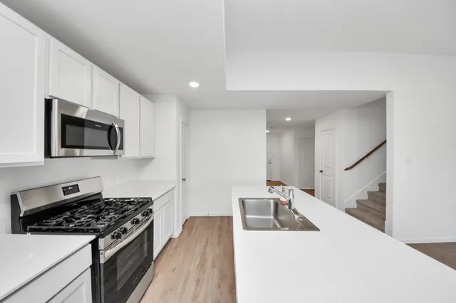 a kitchen with sink a microwave and stove