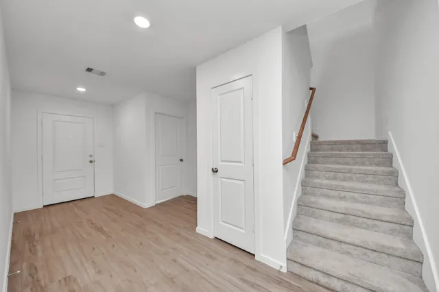 a view of an entryway with wooden floor