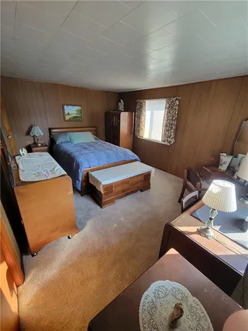 a bedroom with furniture and a lamp