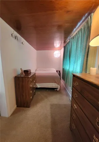 a bed room with a bed and a dresser