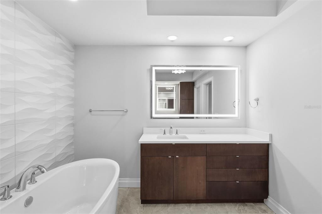 800 Collany Road, Unit 302 St. Petersburg, FL 33715 - Photo 61 of 66 a bathroom with a sink and a bathtub