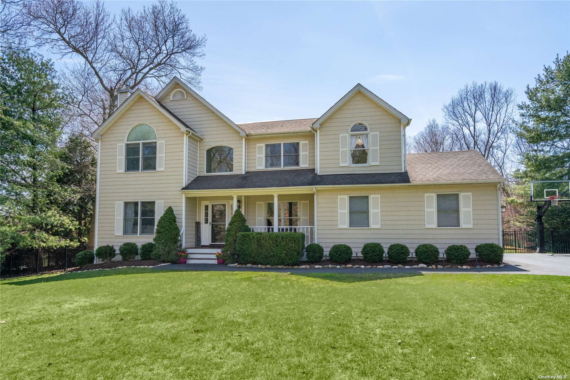 a front view of a house with a yard and green space