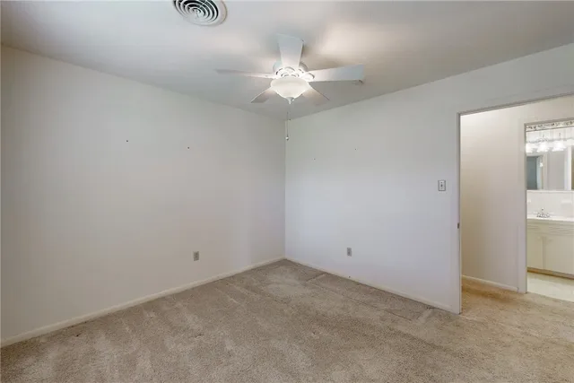 a bathroom with a sink a toilet a mirror and shower